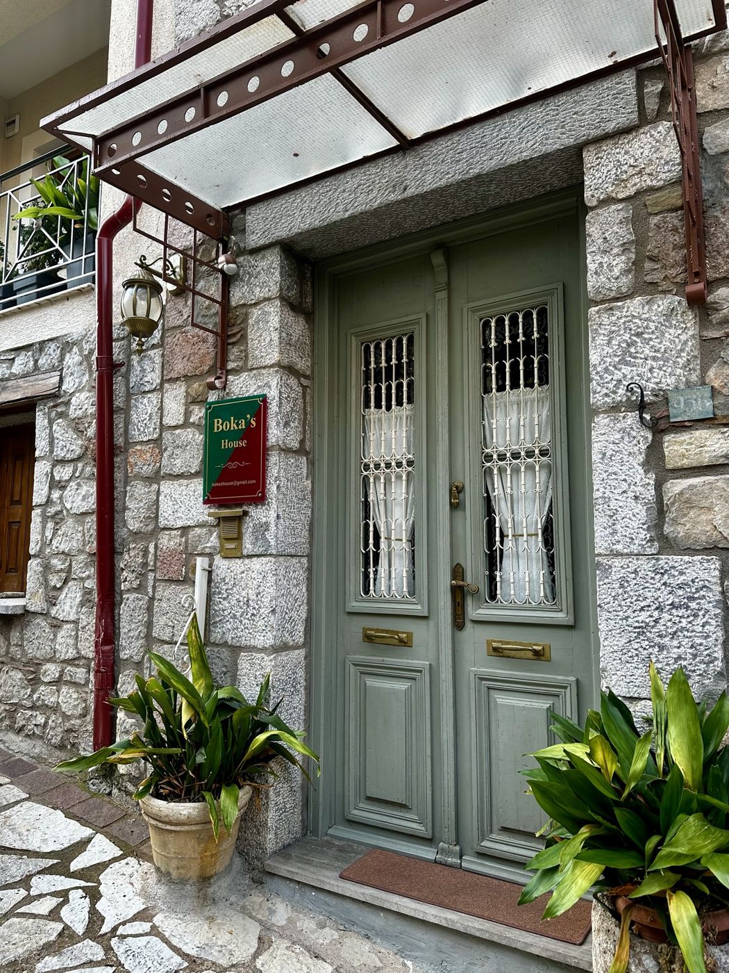 The sage green front door of Boka’s House in Arachova