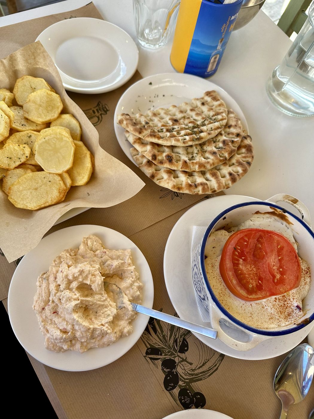 Spicy feta, grilled pita, potatoes and a meatball baked in yogurt and tomato at Kousoulto