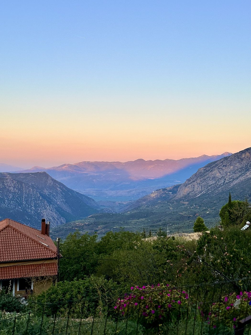 A pink and gold late sunrise over the valley below Arachova