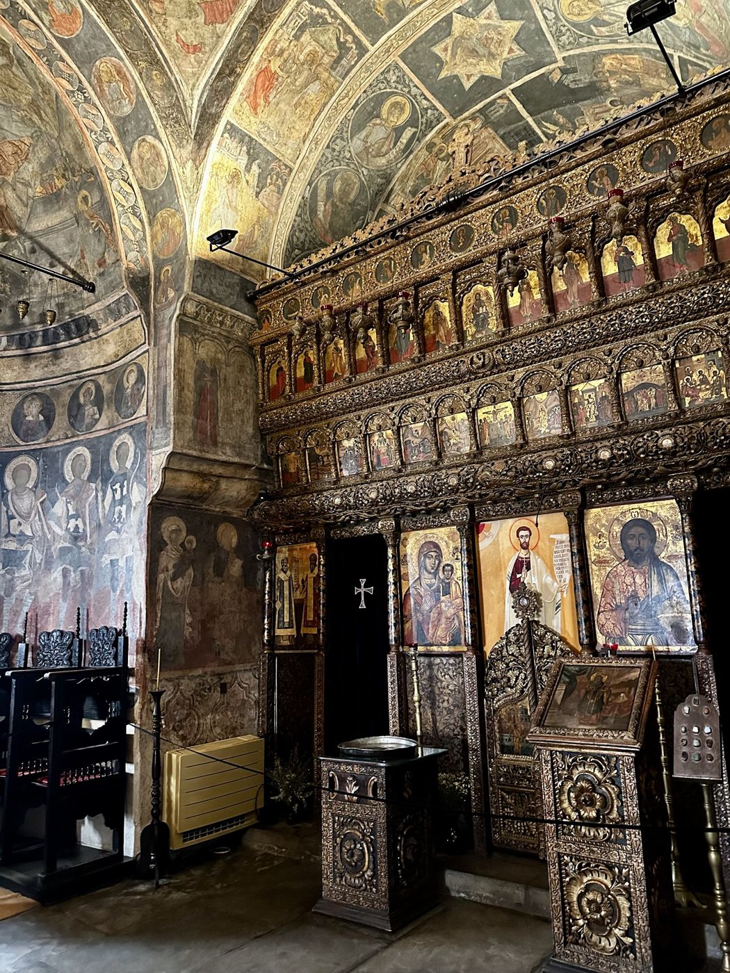 The gilded, carved iconostasis inside Stavropoleos beneath frescoed vaults