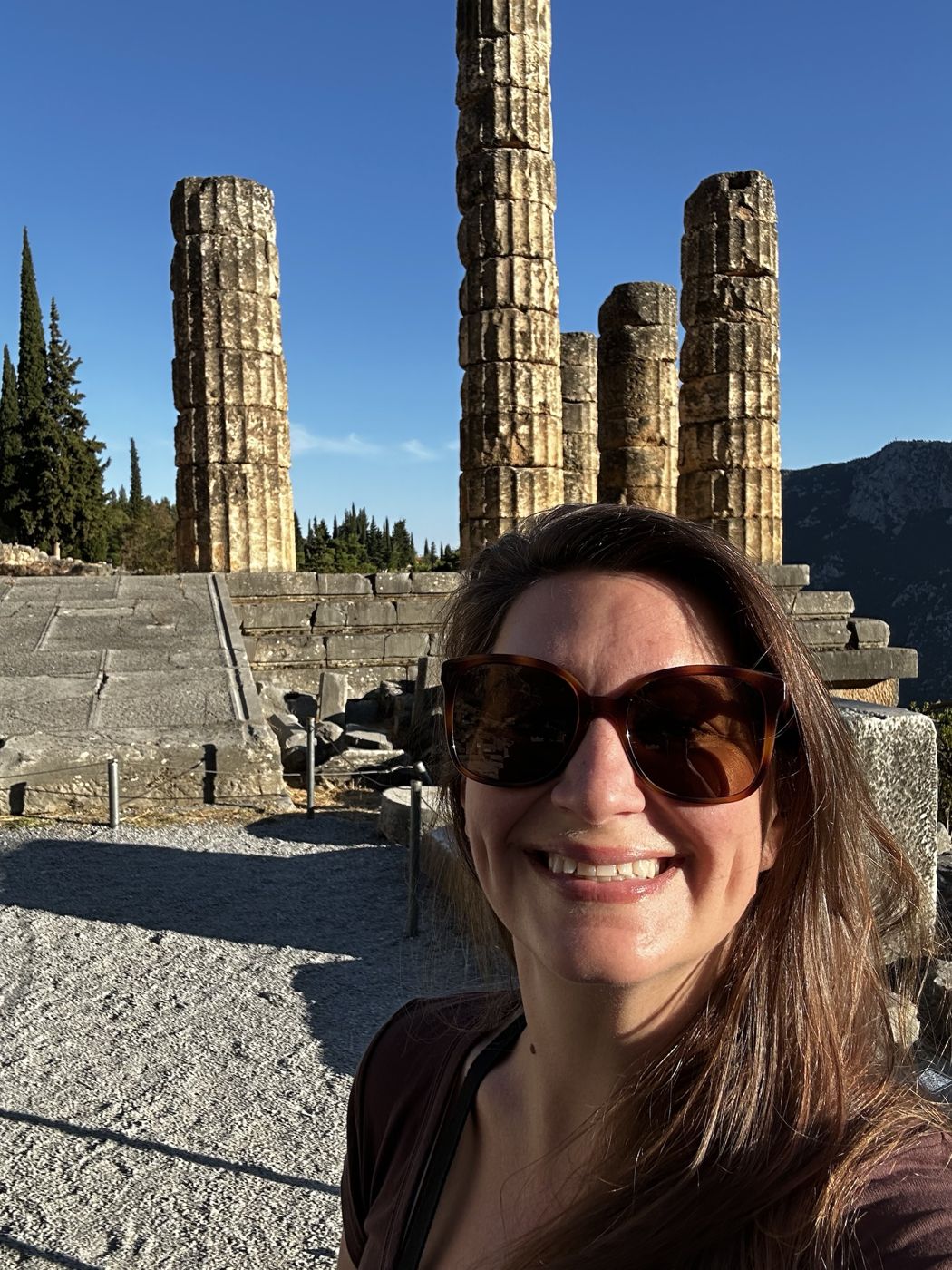 Brittany smiling in front of the columns of the Temple of Apollo